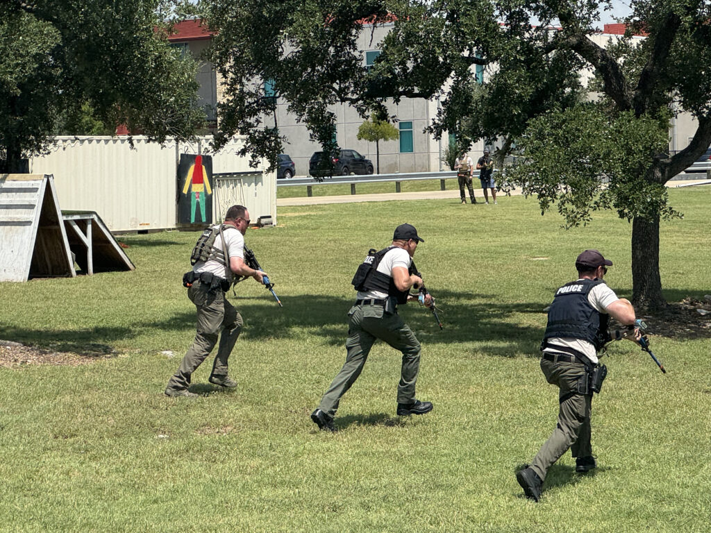 During a vincible training, men are outside in bullet proof vests.
